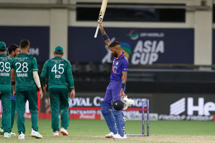 Hardik Pandya lifts his bat in celebration as the defeated Pak team packs up (Images: BCCI Twitter)