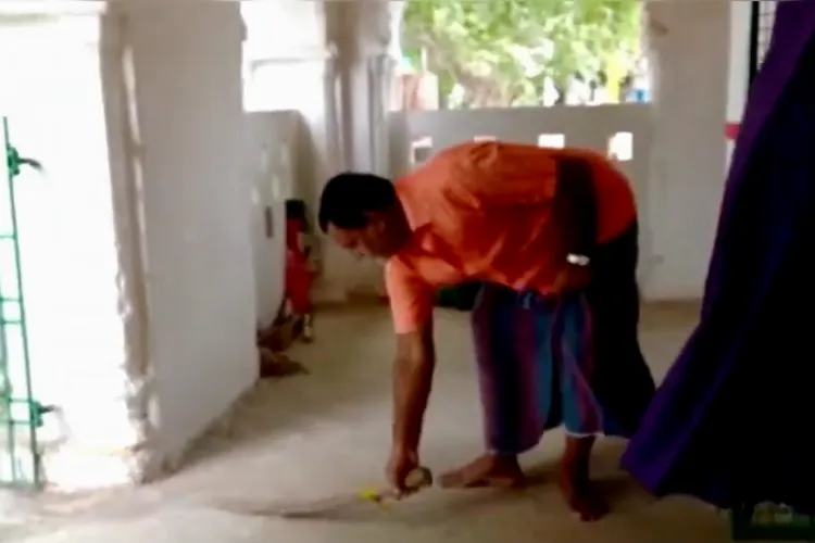 A Hindu villager cleaning the shrine of Data Anwar Shah Shaheed 