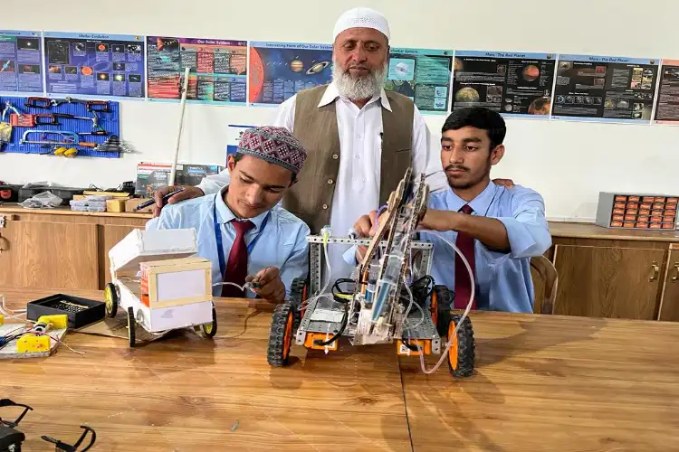 Principal Javed Ahmed Rather with students in school laboratory