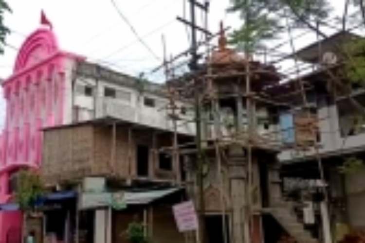 A Durga puja pandal next to a masjid in Sivasagar, Assam