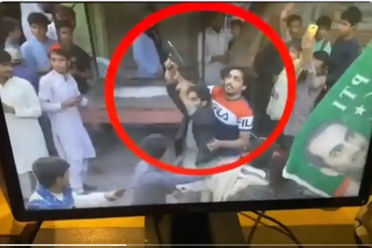 Pakistani man (In black coat) who attacked Imran Khan's container (TV Grab)