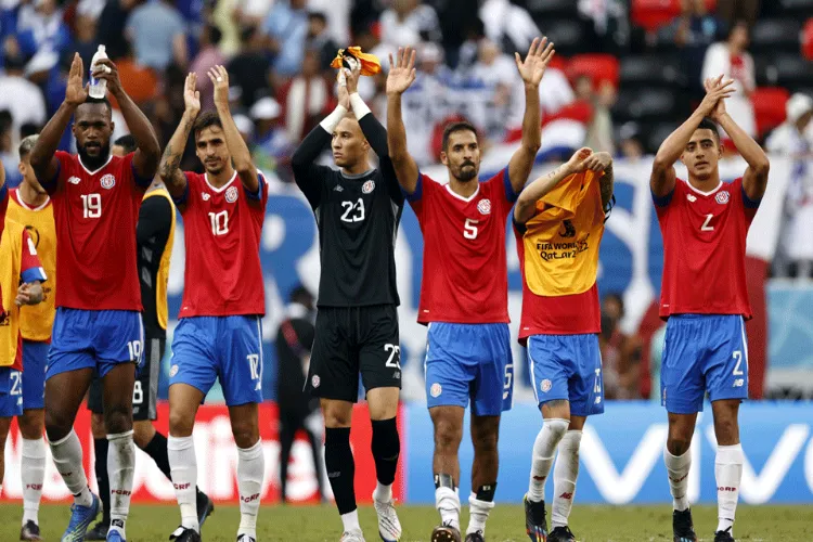Costa Rica players celebrate win over Japan