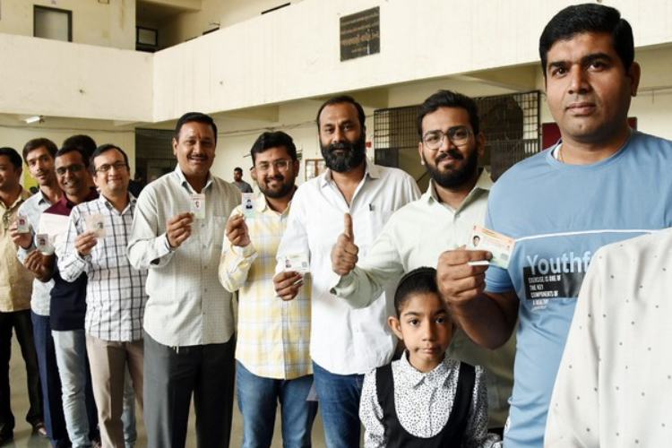 Voters in queue at a polling booth in Rampur