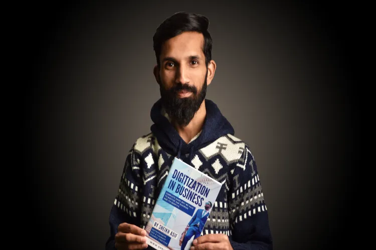 Sheikh Asif, founder, Thames Infotech, holding one of his books