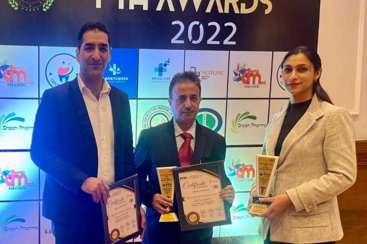 The three Kashmiri doctors with their award