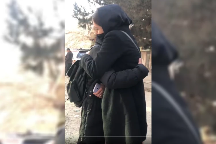 Two Afghan women university students crying outside their institution after they were barred from entering (Twitter)