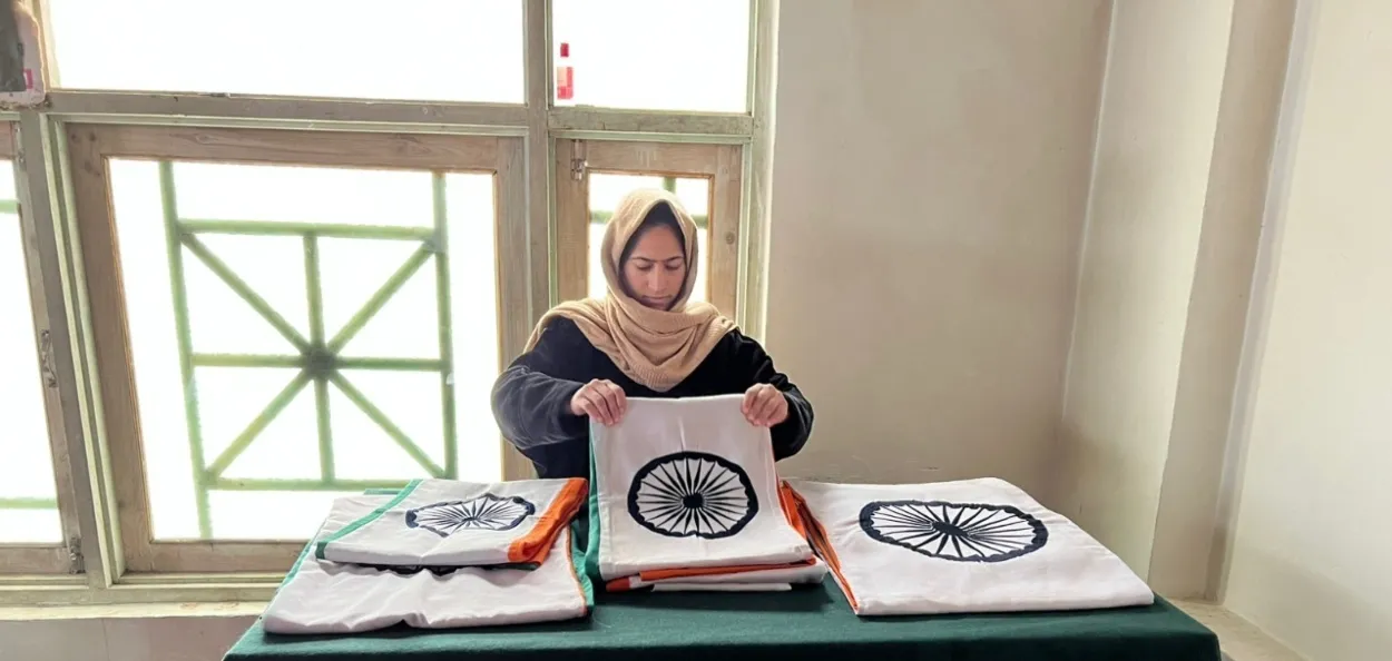 A woman from village Dardpura in Kupwara district folds tricolours ay Vajra skill center