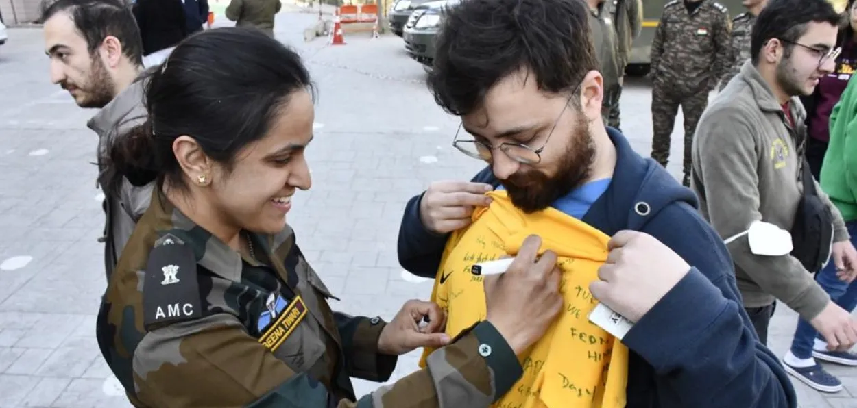 Indian Army Officer signing a T-shirt of the local at Iskenderun, Turkey