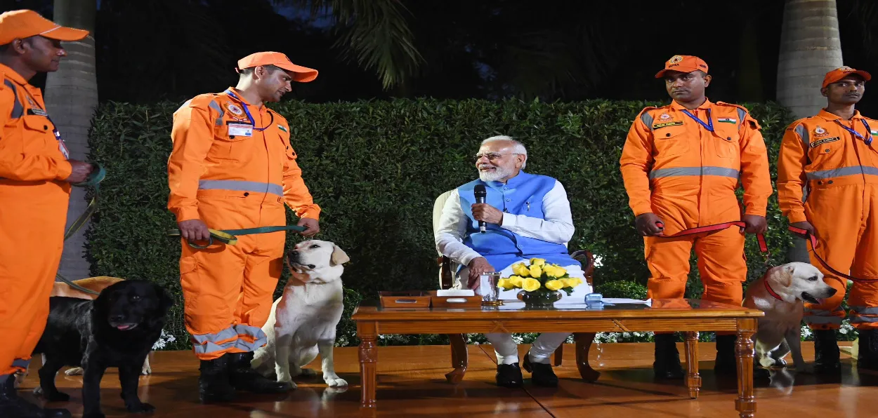 Prime Minister Narendra Modi interacting with NDRF men and dog squad