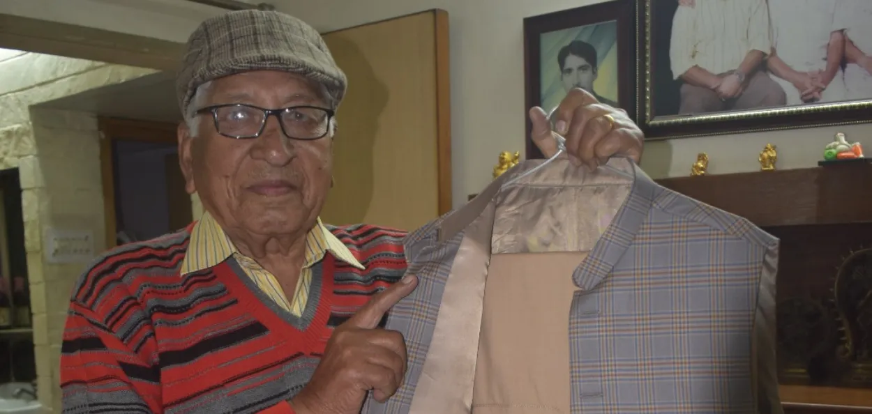 Dayanand Chawla showing his coat that was presented by his relatives to him in Pakistan