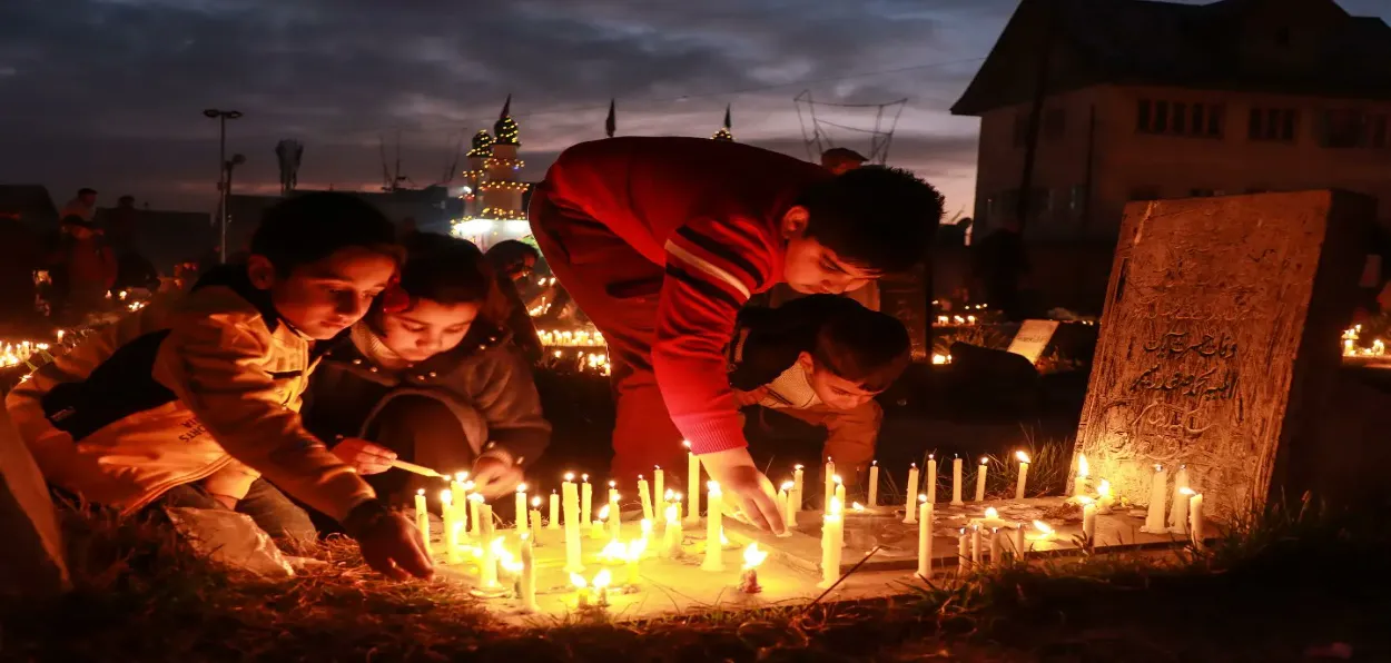 People in Srinagar lighting candles at the graves of their loved ones (Basit Zargar)