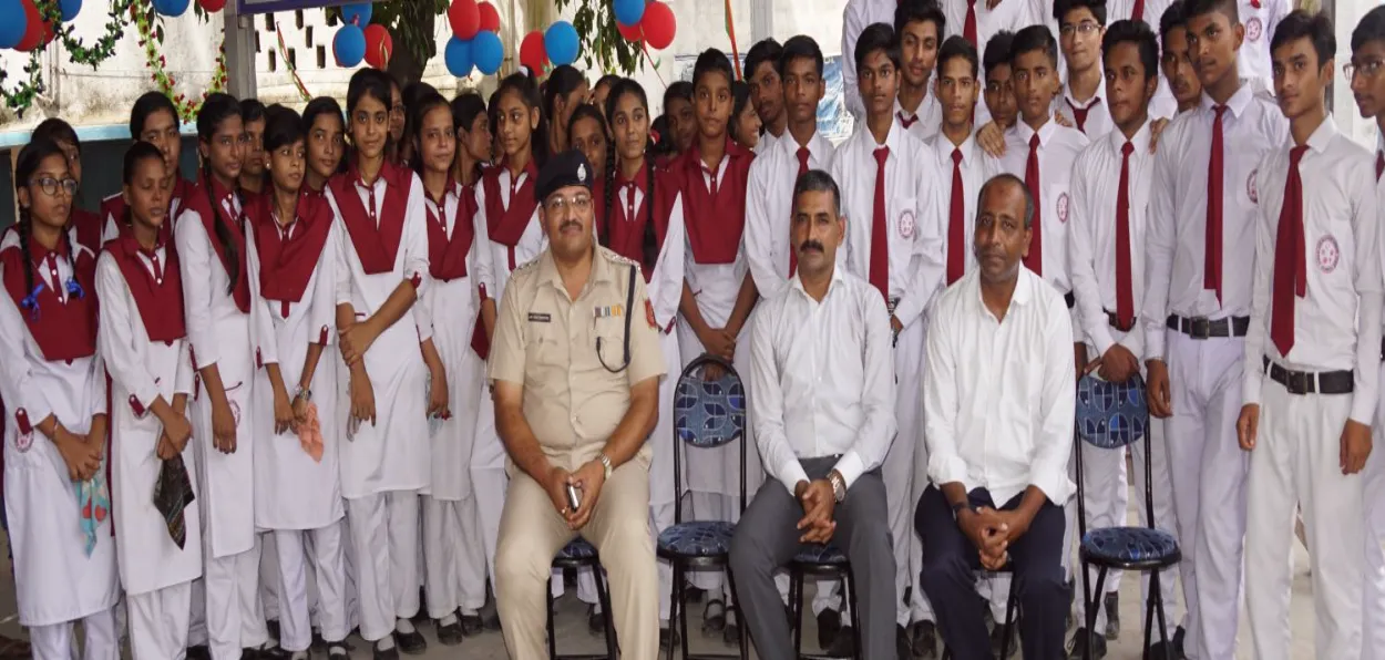 Mamoon Akhtar (sitting extreme right) with local government officers and students of his school (Twitter)