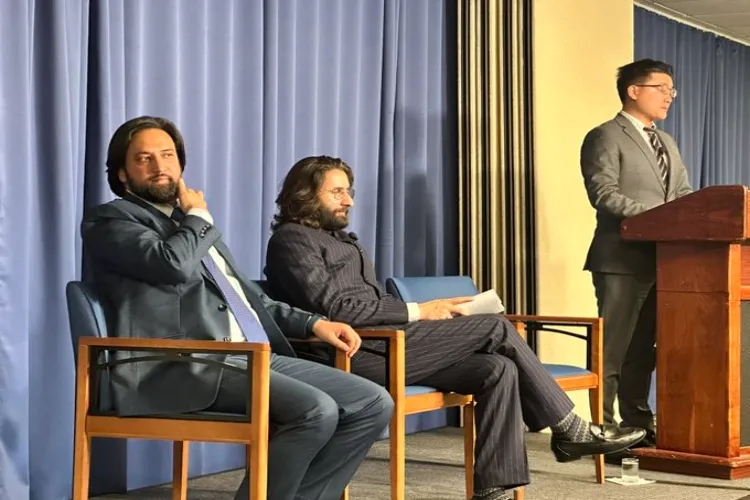 Tauseef Raina and Mir Junaid speaking at a conference