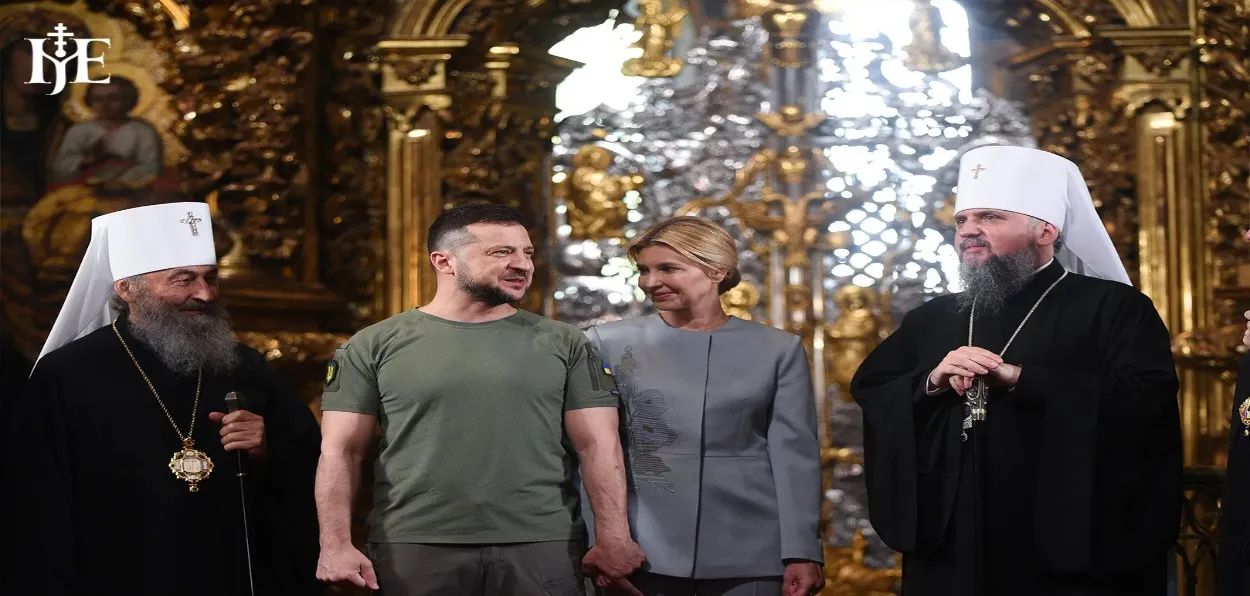 Ukraine's President Volodomyr Zelensky and his wife with priests