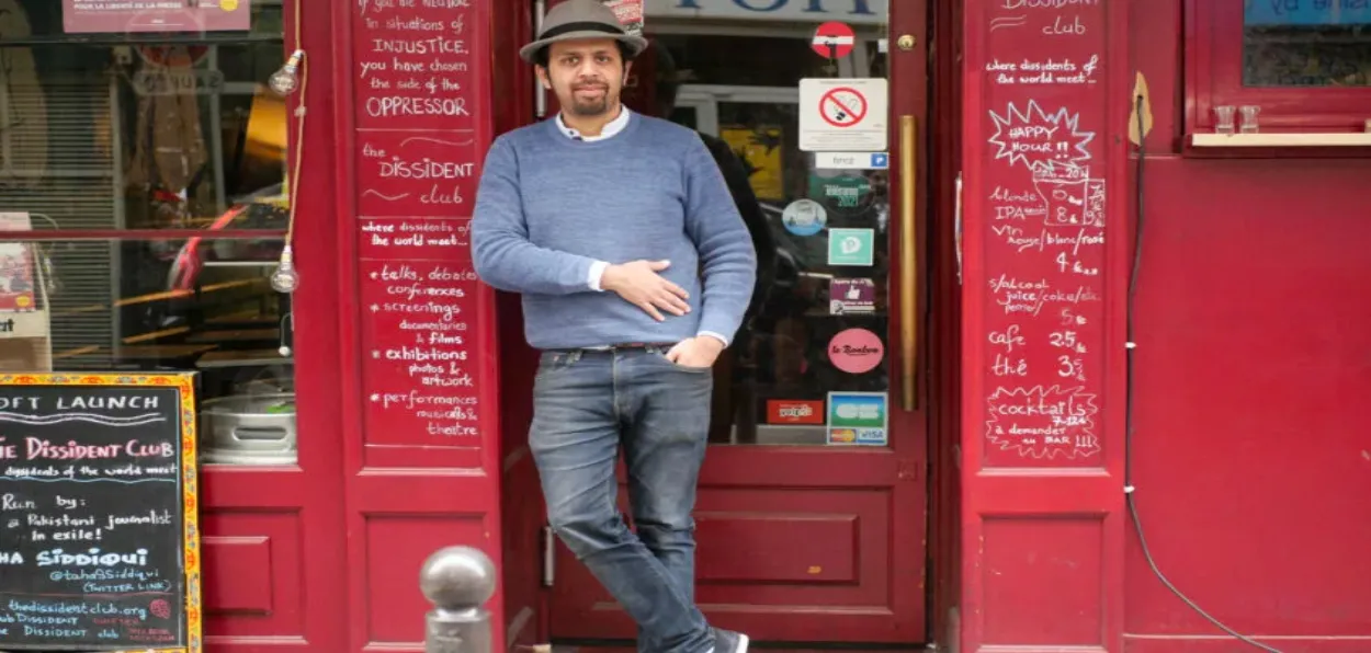 Taha Siddiqui standing outside his Cafe Dissent Club in Paris (Twitter)