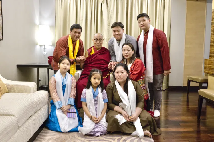 Dalai Lam with Pema Khand (Standing Left) and with his family (Twitter)