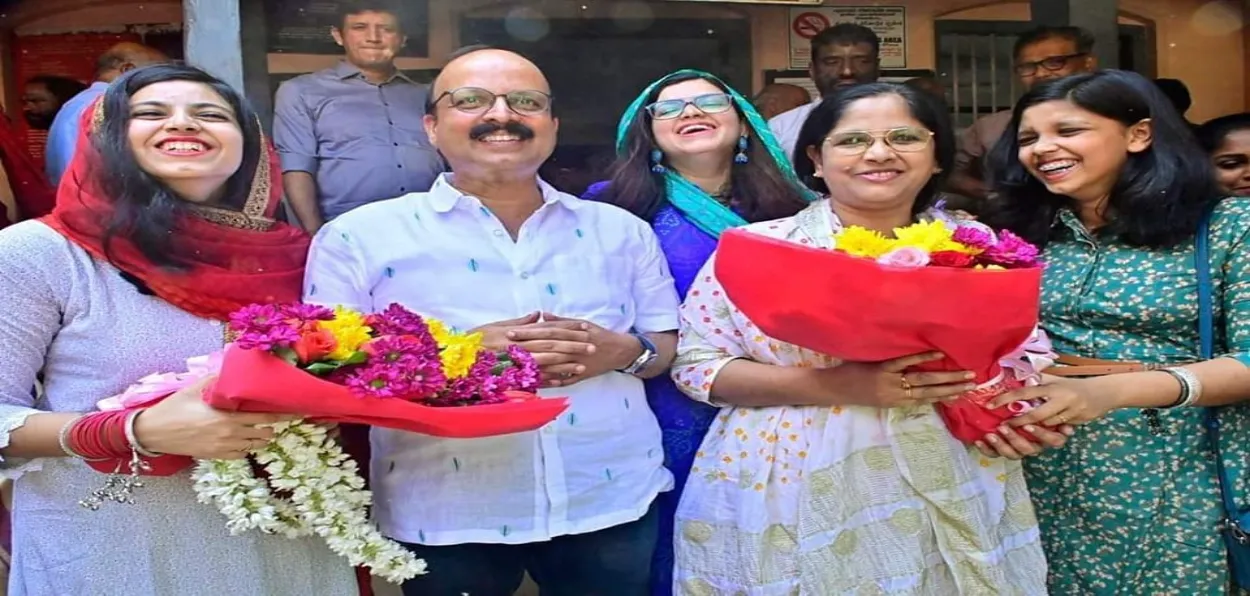 C Shukkur and Dr. Sheena Shukkur with daughters Jasmine, Jezah, and Jebin outside the sub-registrar's office after registering their marriage under the SMA