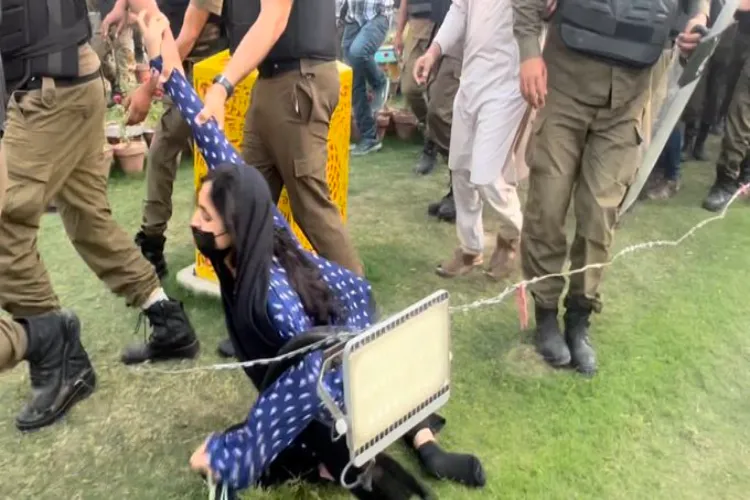 A pro-Imran Khan protester being dragged by Police during ptotests