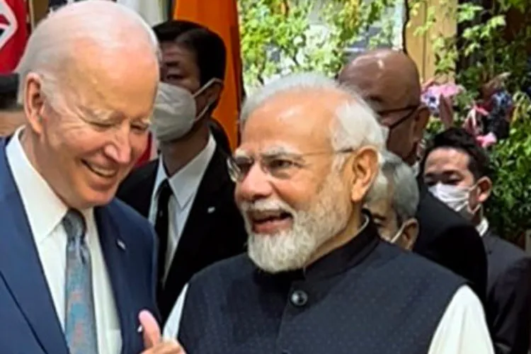 President Joe Biden and Prime Minister Narendra Modi exchanging notes during the QUAD summit in Hiroshima, Japan