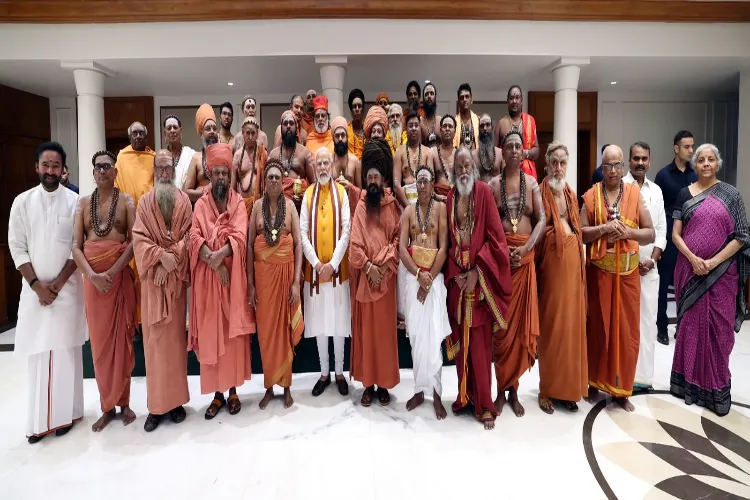 Prime Minister Narendra Modi with priests and Finance Minister Nirmala Sitharaman at his residence