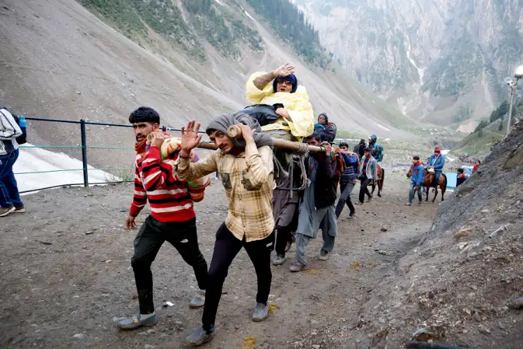 Locals carrying a woman pilgrims to the Holy cave of Amarnath shrine in Kashmir (Pictures by: Basit Zargar)