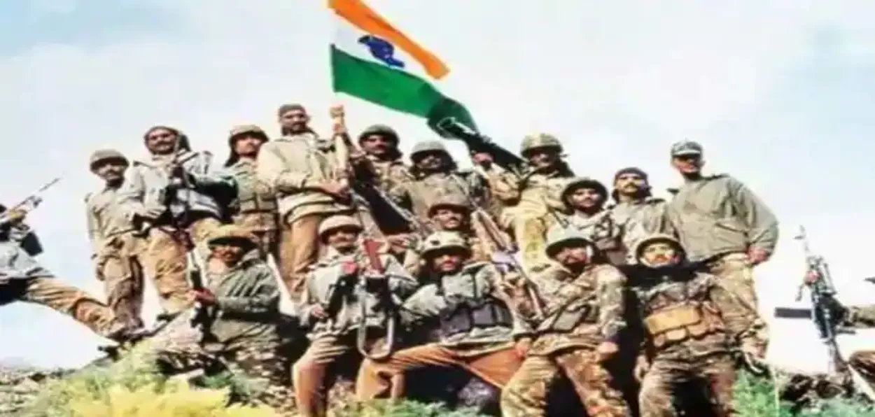 Indian troops celebrating victory at a Kargil peak during the war