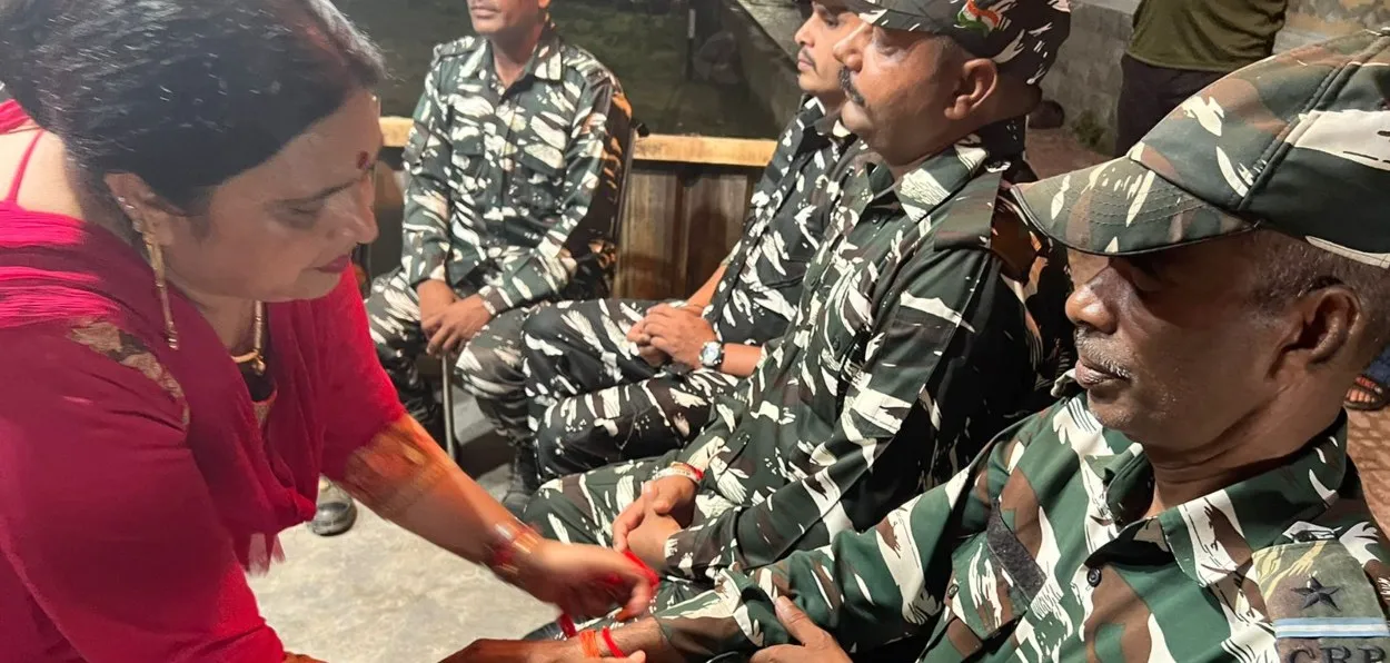 Sarpanch Babita Bhat tying Rakhi on the hand of a security force personnel 