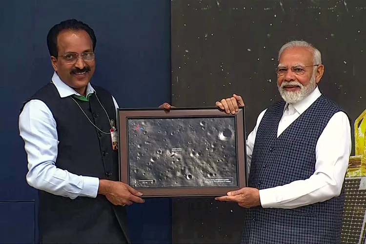 ISRO Chief S Somanath presenting picture of Moon's surface as sent by Lander Vikram to Prime Minister Narendra Modi