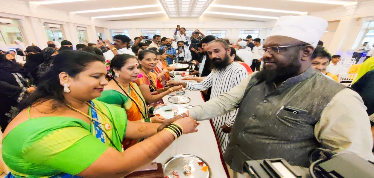 A Hindu woman trying rakhi on the wrist of a Muslim brother on the occasion of Rakshabandhan
