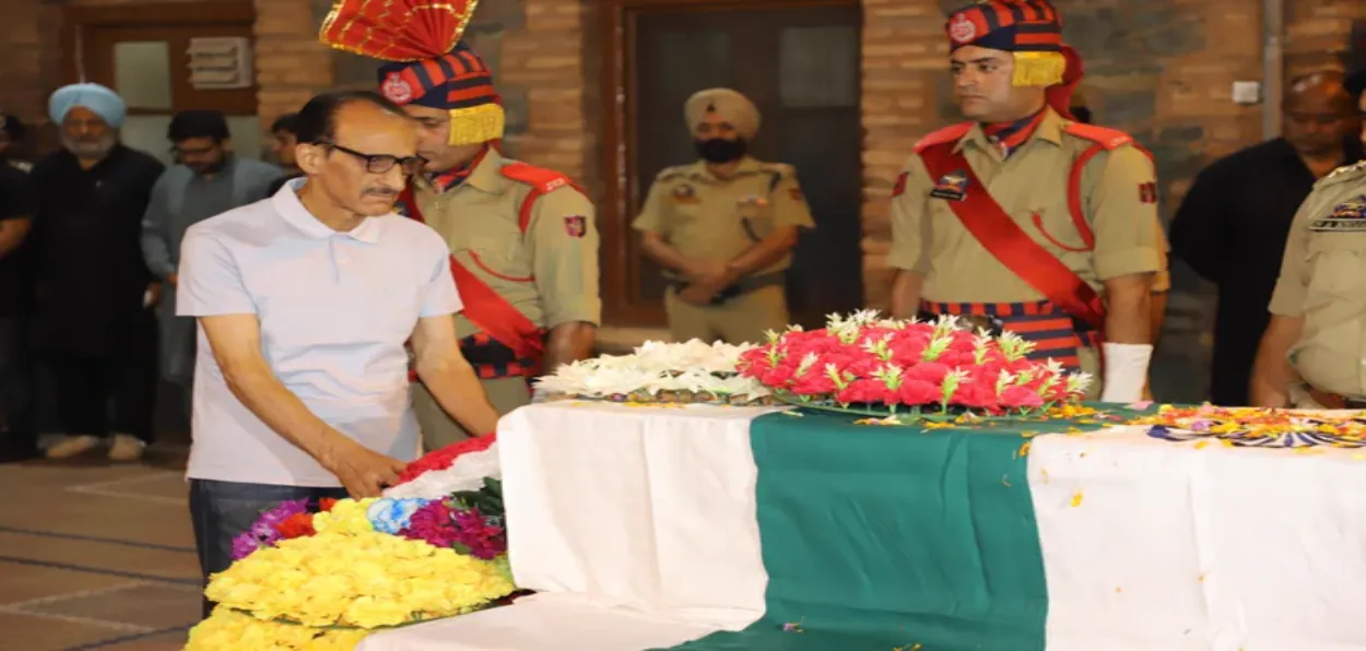 Courageous father paying tribute to his Martyr son: retired IGP, Ghulam Hassan Bhat paying tributes to his son Humayun Bhat, DySP, J&K Police in Srinagar (Pics: Basit Zargar)