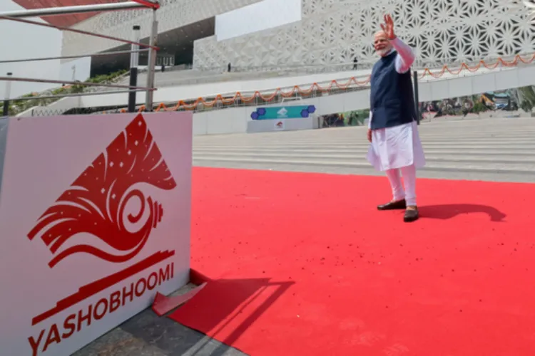 PM Modi waves at a gathering at the inauguration of the first phase of an international convention centre in Delhi