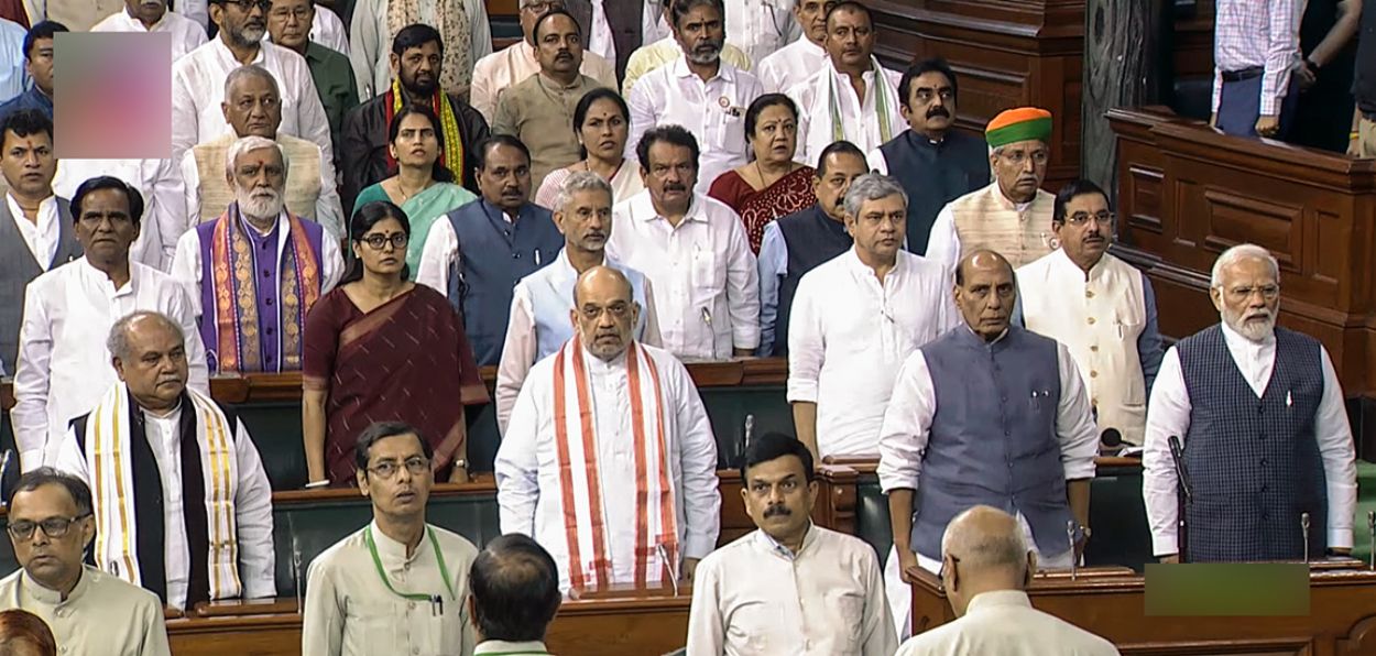 MPs including Prime Minister Narendra Modi stand for the national anthem in the parliament house on the first day of the special session
