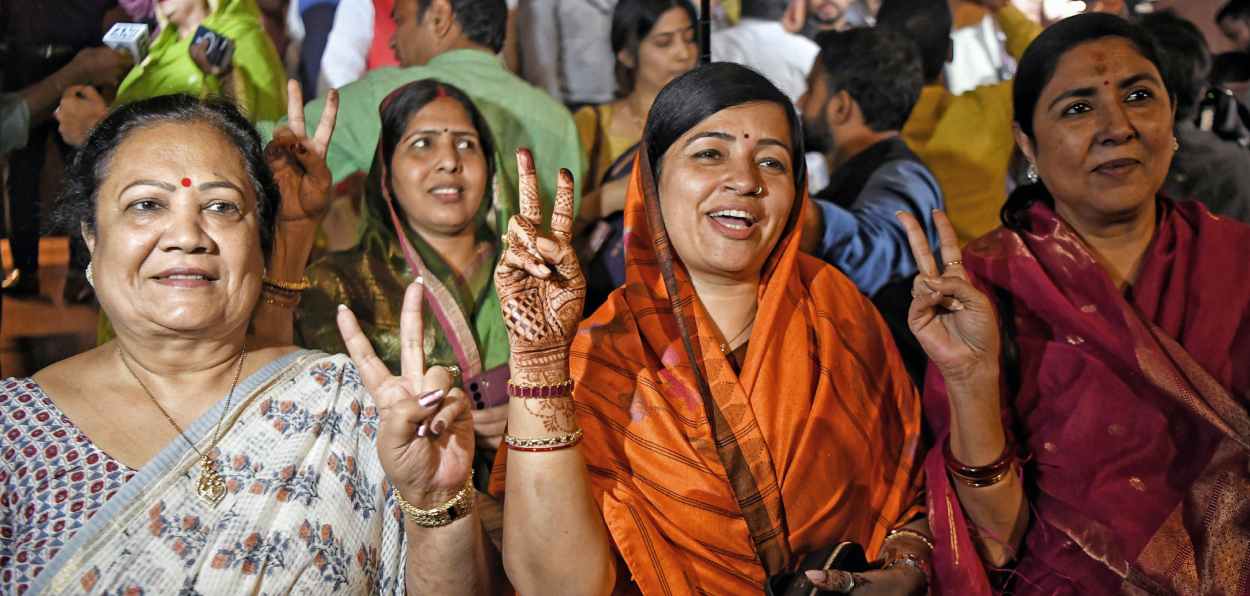 Women MPs including Riti Pathak show victory sign after Lok Sabha passed the motion concerning the Women's Reservation Bill during the Special Session, at the Parliament in New Delhi on Wednesday.
