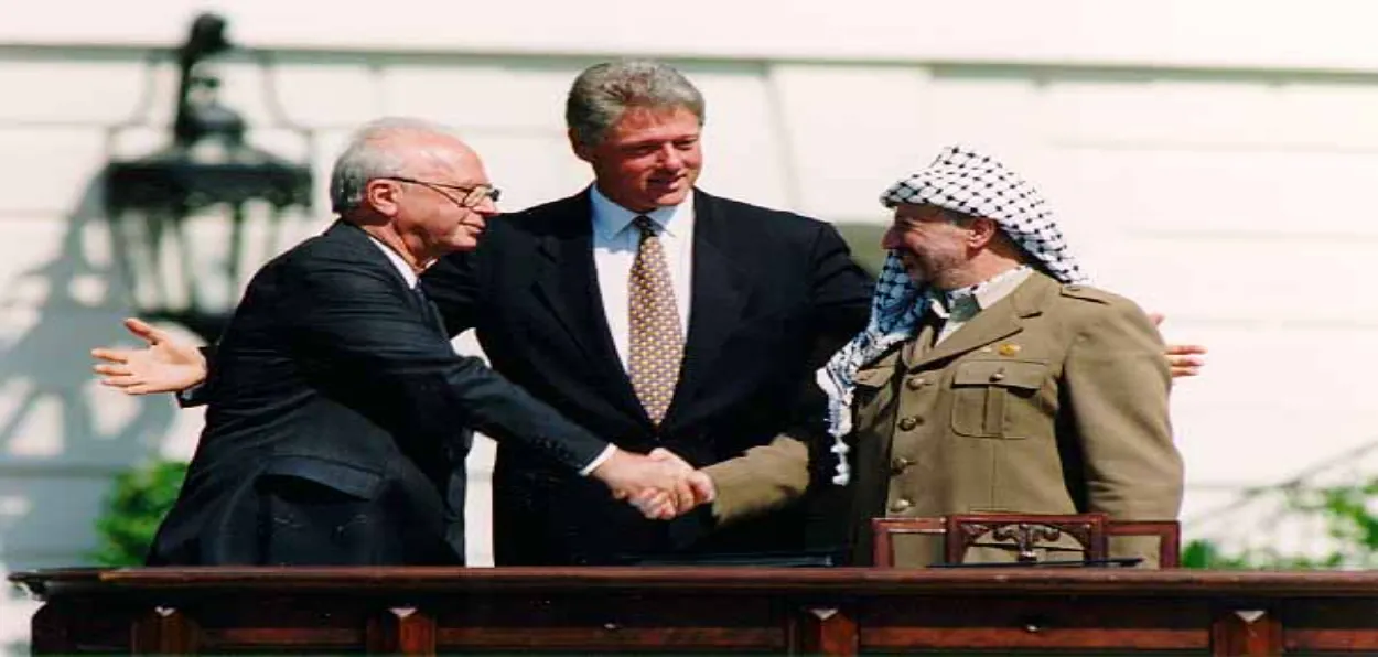 Accord that didn't resolve the conflict: PLO chairman Yasser Arafat and Israeli Prime Minister Yitzak Rabin shaking hands in the presence of the US President Bill Clinton before signing peace accord under the banner of Oslo accords