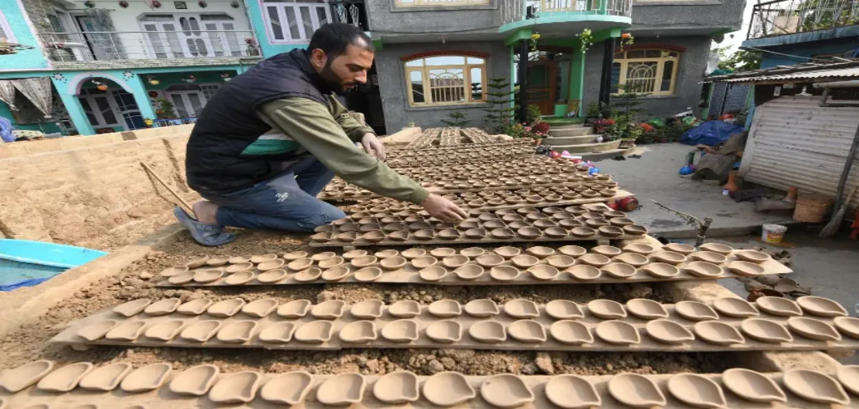 Umer making earthen lamps for Diwali (Basit Zargar)