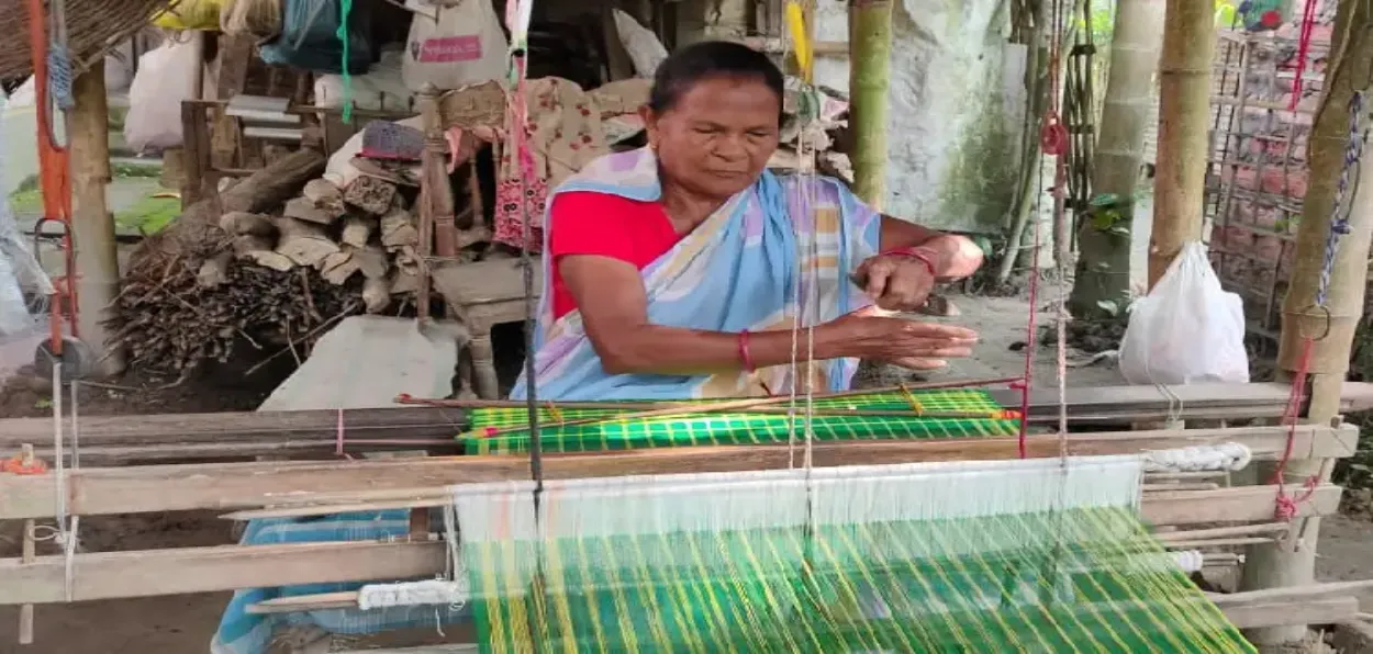 A weaver at her loom in Assam's Jajori village