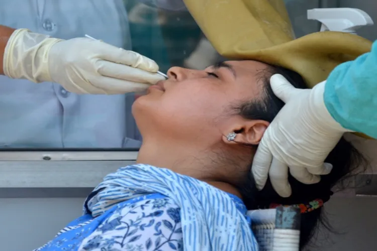 Medical officers taking a nasal swab sample to test COVID
