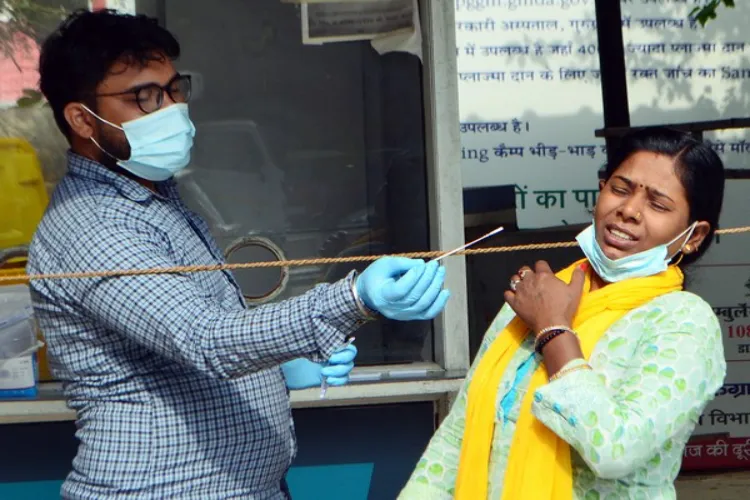 A file image of a medical worker taking a nasal swab to test a lady for COVID 