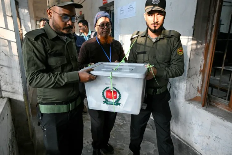 Security officials carrying a sealed ballot box after voting ended at a polling station in Dhaka