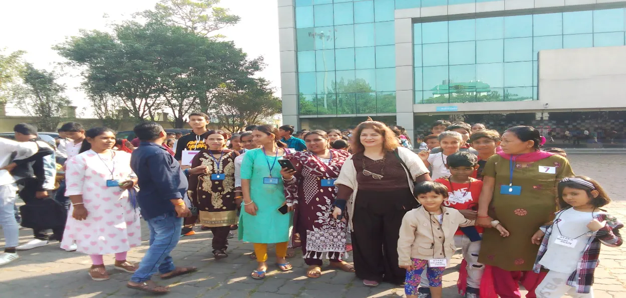 Yasmin (In black trousers and shirt) with teachers and children on an outing
