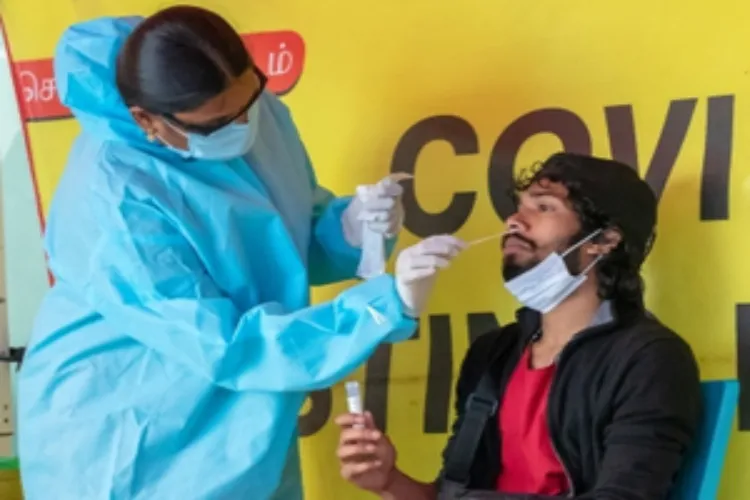 A medical worker using a nasal swab to diagnose Covid infection