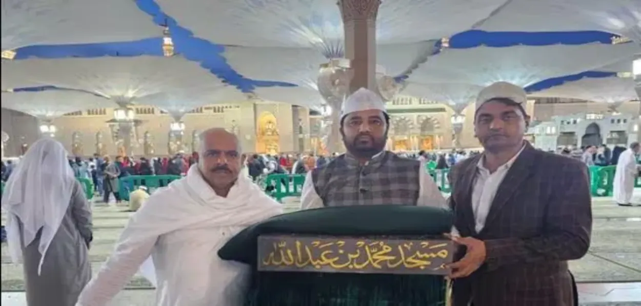 Haji Arafat Shaikh with the packet containing consecrated brick that arrived from Makkah