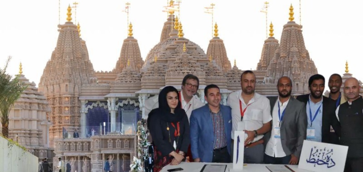 Mohammad Ajmal (Wearing identity card with red strap) with his team in front of the BAPS Mandir in Abu Dhabi