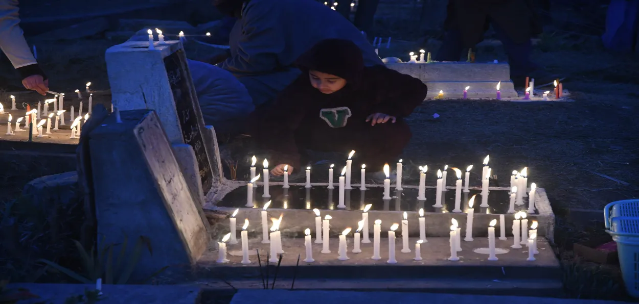 A girl lights candles on a grave of his relative in Srinagar on Shab-e-barat (Basit Zargar)