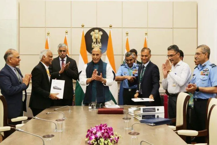 Defence Minister Rajnath Singh with officials at the signing of MoU for procuring military equipment