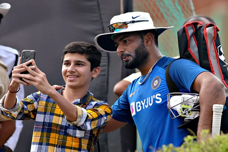 Indian cricketer Rishab Pant with a fan 