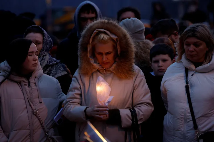 Familirs lighting candles for their loved ones who died in the terroruist attack at crocus Hall
