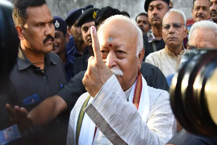 RSS Chief Mohan Bhagwat showing his inked left-hand forefinger, after casting his vote in Nagpur