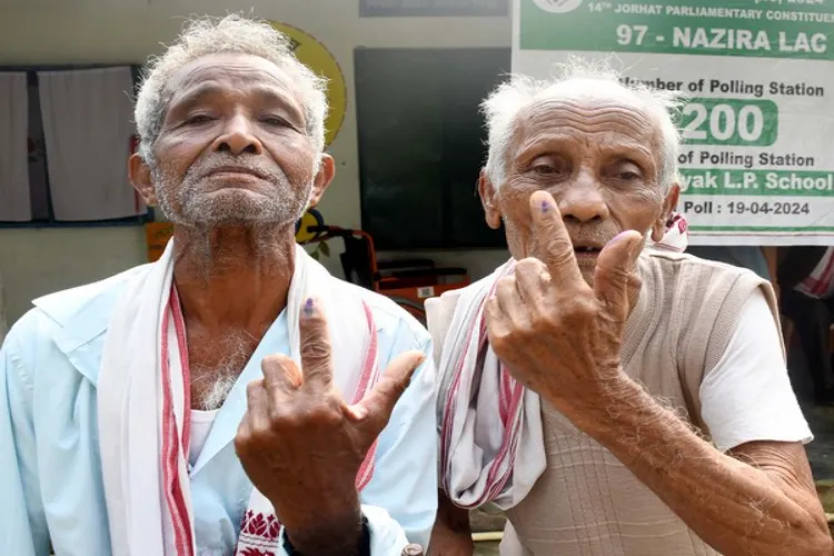 Elderly men show the ink mark on their fingers after exercising their franchise in Assam