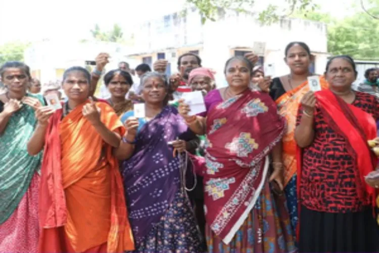 Women in Tamil Nadu showing their voters cards and ballot ink mark on their fingers